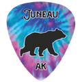 A guitar pick featuring a blue and purple tie-dye pattern with a black bear silhouette in the center, the word 'JUNEAU' at the top, and 'AK' at the bottom.