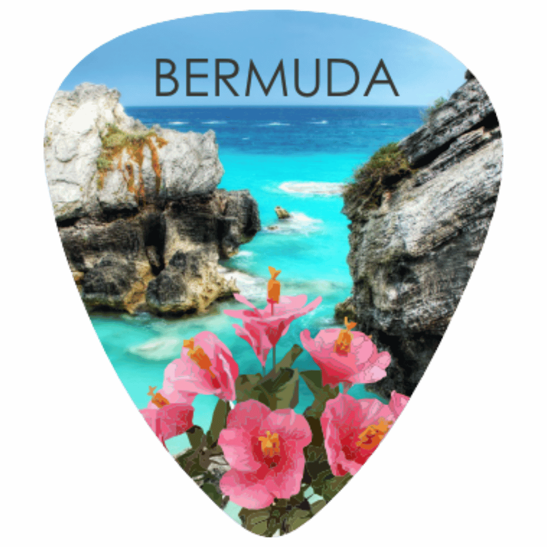 A guitar-pick-shaped Bermuda travel print featuring a scenic coastal view with turquoise water, rocky cliffs, and pink flowers, with the word BERMUDA printed at the top.