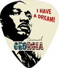 A guitar pick featuring a stylized black-and-white portrait of Martin Luther King Jr., red text reading 'I HAVE A DREAM!', and 'Savannah GEORGIA' in blue and red lettering on a cream background.