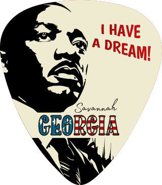 A guitar pick featuring a stylized black-and-white portrait of Martin Luther King Jr., red text reading 'I HAVE A DREAM!', and 'Savannah GEORGIA' in blue and red lettering on a cream background.