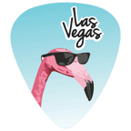 A guitar pick featuring a pink flamingo wearing black sunglasses against a light blue gradient background, with the words 'Las Vegas' in black script and white outline near the top.