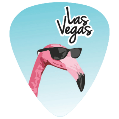 A guitar pick featuring a pink flamingo wearing black sunglasses against a light blue gradient background, with the words 'Las Vegas' in black script and white outline near the top.