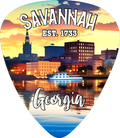 A guitar-pick-shaped souvenir charm featuring a Savannah, Georgia skyline at sunset with a boat on the water, and the text 'SAVANNA EST. 1733' and 'Georgia'.