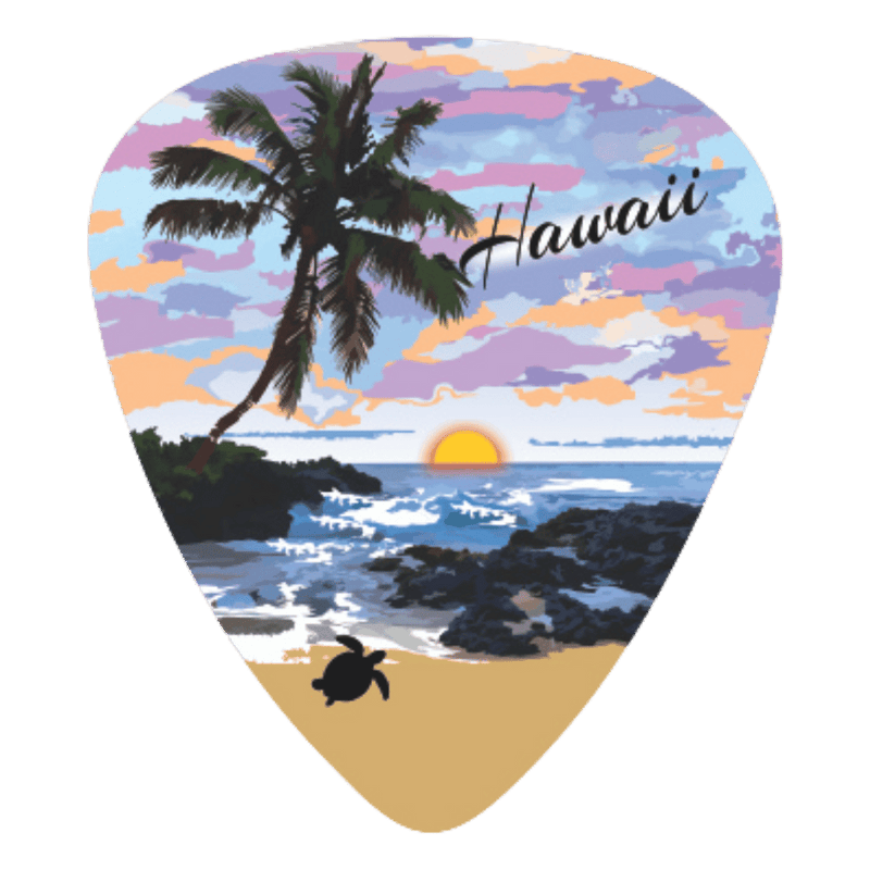 A guitar-pick-shaped sticker or patch featuring a Hawaii beach sunset scene with a palm tree, ocean waves, rocky shore, sandy beach, and the word "Hawaii" in script.
