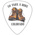 A white guitar-pick-shaped graphic with the words “GO TAKE A HIRE” at the top and “COLORADO” at the bottom, centered around an illustration of a pair of brown hiking boots. The design appears to be the product artwork itself rather than a lifestyle scene or auxiliary chart.
