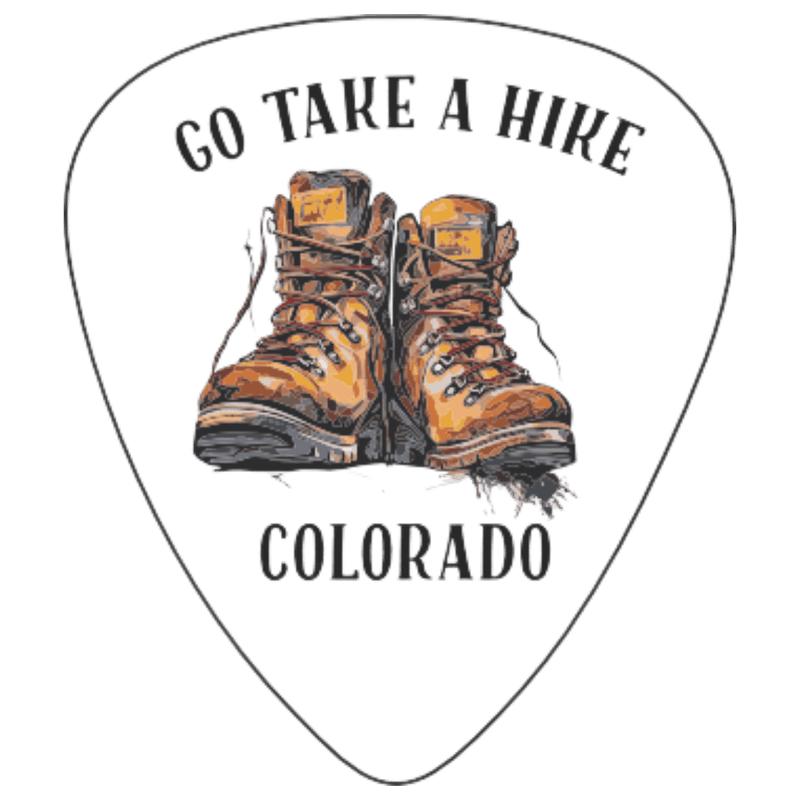 A white guitar-pick-shaped graphic with the words “GO TAKE A HIRE” at the top and “COLORADO” at the bottom, centered around an illustration of a pair of brown hiking boots. The design appears to be the product artwork itself rather than a lifestyle scene or auxiliary chart.