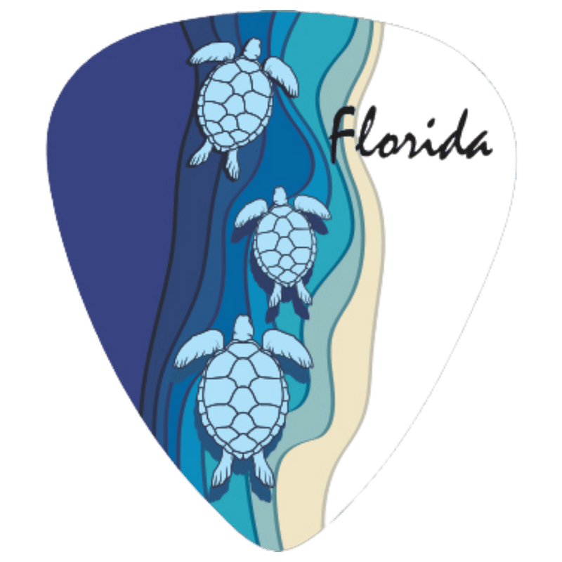 A guitar pick-shaped graphic featuring three illustrated sea turtles swimming in layered blue water, with a sandy beige shoreline and the word 'Florida' in black script on a white background.