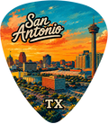 A guitar pick featuring a colorful San Antonio skyline illustration with the words 'San Antonio' at the top and 'TX' at the bottom, shown on a plain white background.